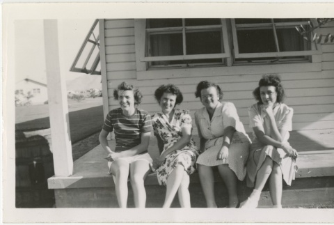 Four women sitting on a porch (ddr-manz-7-88)