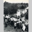 Japanese refugees row a boat through flooded streets (ddr-densho-299-112)
