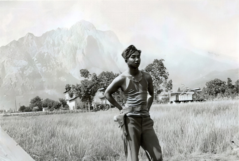 Shiro Aoki in army fatigues with mountain in background (ddr-densho-474-243)