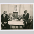 Four men around memorial photos (ddr-densho-474-47)