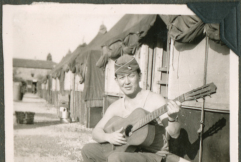 Soldier playing a guitar (ddr-densho-201-537)