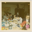 Group seated at a table opening gifts (ddr-densho-426-169)