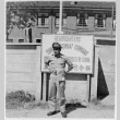 Serviceperson in front of sign (ddr-densho-1007-59)