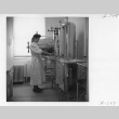 Mary Shimoda using the operating room sterilizer (ddr-fom-1-858)