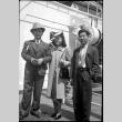 Tomoye (Nozawa) Takahashi in center, Henri Takahashi on right, with unknown man on board ship (ddr-densho-426-1982)