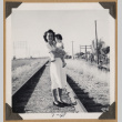 Woman holding a baby on railroad tracks (ddr-densho-542-348)