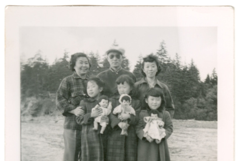 Family of six in field with dolls (ddr-densho-430-157)