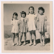 Four Japanese American girls standing in a row (ddr-densho-362-27)