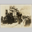 Two soldiers distributing bread to a crowd of civilians (ddr-njpa-13-1351)
