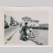 Tomoye Takahashi with Masako and Norman seated on wall (ddr-densho-426-998)