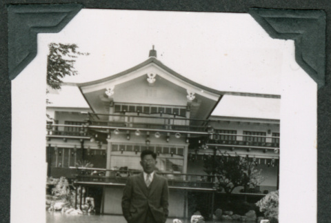 Man on rock in front of Japanese Pavilion (ddr-densho-475-559)