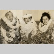 Samuel Wilder King, his wife and a young woman wearing many leis (ddr-njpa-2-557)