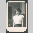 Woman outside next to a flower (ddr-densho-471-125)
