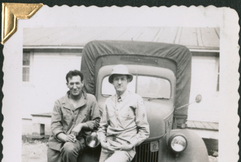 Two men leaning on truck (ddr-densho-434-190)
