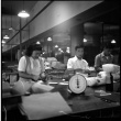 Three people packing items for shipping (ddr-densho-426-947)