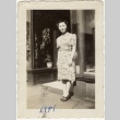 Eiko Kosai standing in front of the Grand Hotel (ddr-densho-349-33)
