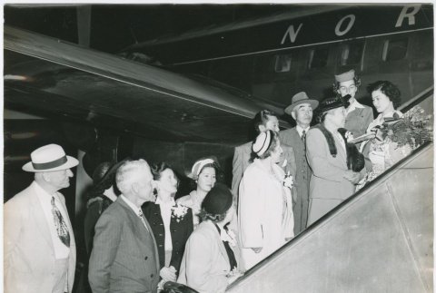 Group of people on aircraft ramp welcoming woman in kimono (ddr-densho-332-35)