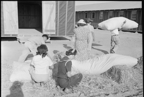 Japanese Americans filling straw mattresses (ddr-densho-37-403)