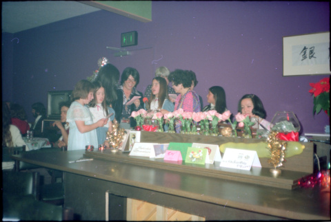 Group standing around piano, singing (ddr-densho-426-605)