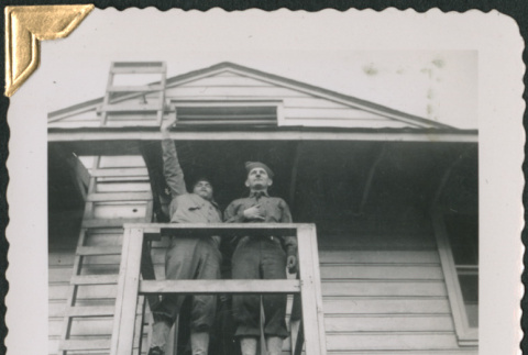 Two men on fire escape (ddr-densho-434-41)