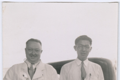 Two men in front of a car (ddr-densho-329-825)