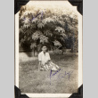Woman sitting on lawn (ddr-densho-587-55)
