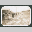 Crowd walking in a muddy camp (ddr-densho-471-14)