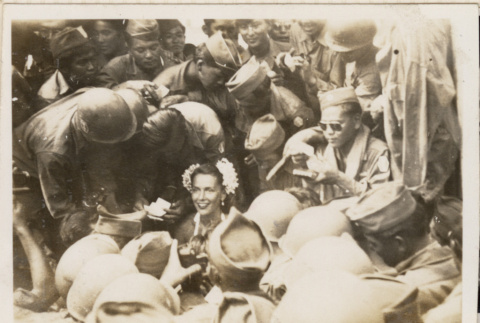 Woman surrounded by soldiers (ddr-densho-466-413)