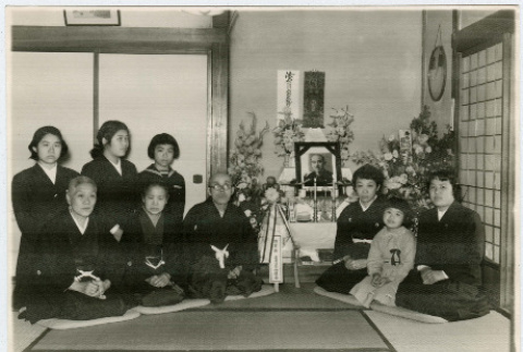 Family poses by memorial table (ddr-densho-359-1156)