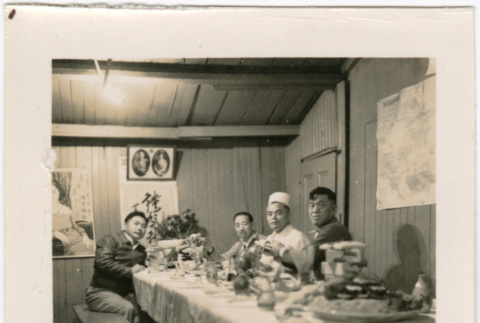Four men seated at banquet table, one man in chef's hat (ddr-densho-426-1400)