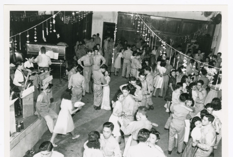 Soldiers from Allied Translator and Interpreter section dancing with civilians in post-war Tokyo (ddr-densho-1007-98)