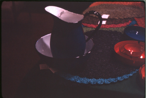 Display of bowl and pitcher, placemats, ashtrays (ddr-densho-426-350)