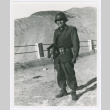 Serviceperson standing in front of fence (ddr-densho-1007-64)