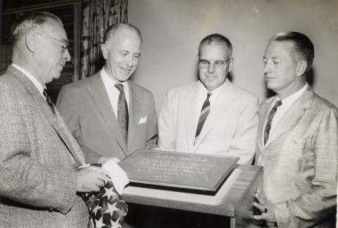Four men looking at the Johnson Hall dedication plaque (ddr-njpa-2-1026)