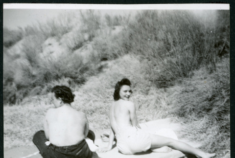 Photograph of two women sunbathing topless near Manzanar (ddr-csujad-47-181)