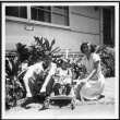 Nisei man and woman pose with child (ddr-densho-363-131)