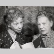 Two women looking at a Honolulu Symphony brochure (ddr-njpa-2-567)