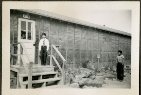 Boy standing on barrack stairs (ddr-csujad-32-20)
