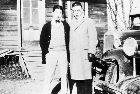 Two Nisei in front of the Bellevue Japanese community clubhouse (ddr-densho-9-22)