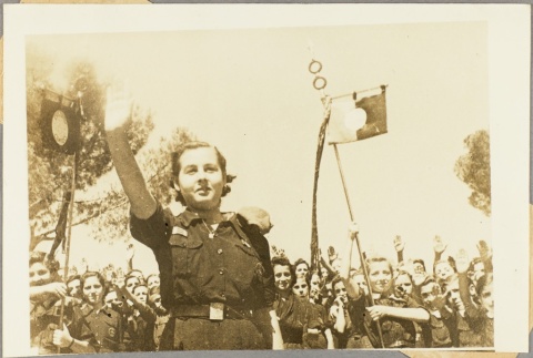 Spanish youth auxiliary members saluting and carrying flags (ddr-njpa-13-638)