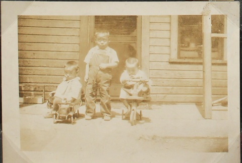 Three brothers in front of their house (ddr-densho-259-7)