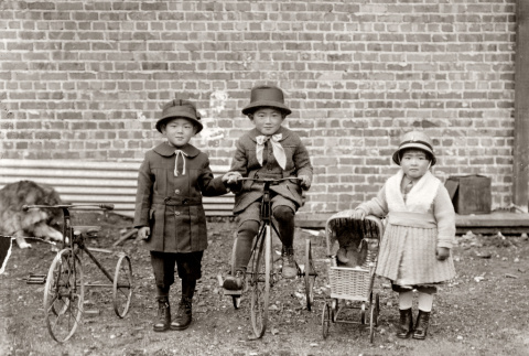 Three children with tricycles (ddr-ajah-6-746)