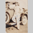 Well-dressed man standing next to car (ddr-densho-464-106)