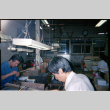 Men seated at work benches (ddr-densho-426-554)