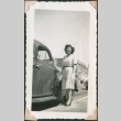 Woman standing near a car (ddr-densho-321-179)