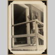 Man standing outside a doorway (ddr-densho-542-543)