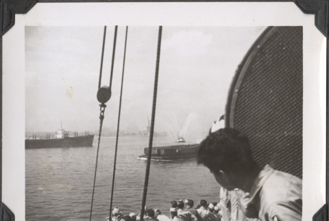 Men looking at fireboat from ship (ddr-densho-466-169)