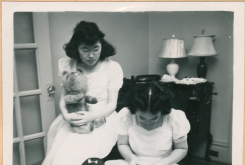 Martha Nozawa holding teddy bear, Helen Takahashi with flowers (ddr-densho-410-523)