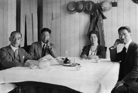 Three men and woman seated at a table (ddr-ajah-6-555)
