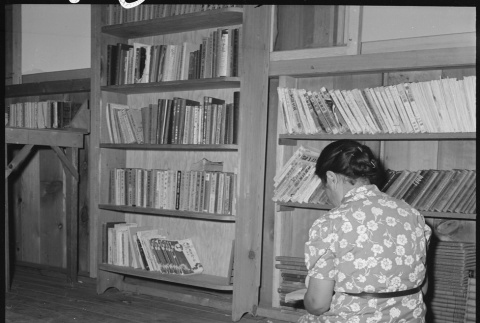 Japanese American reading in library (ddr-densho-151-436)